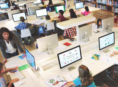 Children and teachers using computers